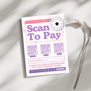 以下が含まれることがあります： ピンクとパープルのサインに「Scan To Pay」の文字と、異なる支払い方法のための3つのQRコードが書かれています。サインには「Also Accepted: GPay Pay」と「Thank you for your purchase. We'd love to hear your feedback!」の文字も書かれています。