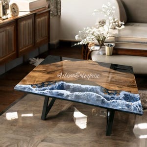 Handcrafted epoxy resin dining table featuring a blue resin river a glossy finish, designed for dining rooms or office spaces.