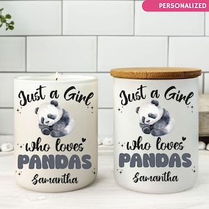 May include: Two white ceramic candle holders with bamboo lids. Each features a sleeping panda illustration and the text "Just a Girl who loves Pandas" with a personalized name. One candle is lit.