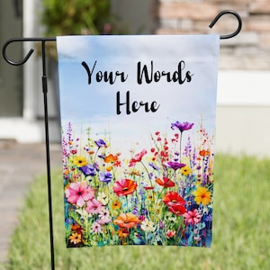 May include: A garden flag with a watercolor painting of a field of colorful flowers. The flag has the text "Your Words Here" printed on it.