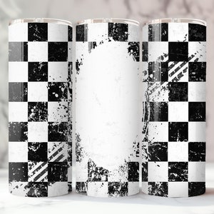 May include: A cylindrical tumbler featuring a black and white checkered pattern with a distressed, weathered texture. The design includes a central white oval space for personalization and graphic tire track marks across the checkered surface.