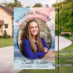 May include: A blue and pink garden flag with a photo of a woman in a blue sweater. The flag reads "In Loving Memory" and "Danielle Walker 2.12.1982 - 1.24.2024".