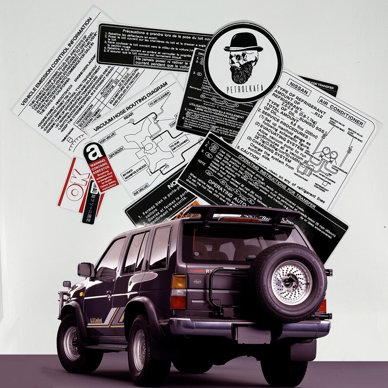 May include: A black Nissan Pathfinder SUV with a spare tyre mounted on the back. The vehicle has a sticker on the rear window that says "R12" and "Air Conditioner". There are several other stickers on the vehicle, including one with a skull and crossbones.