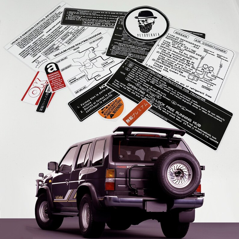 May include: A black Nissan Pathfinder SUV with a spare tyre mounted on the back. The vehicle has a sticker on the rear window that reads "Free Running Hub".