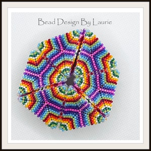 May include: A colorful beaded hexagon with a rainbow pattern. The beads are arranged in a geometric design, creating a kaleidoscope effect.