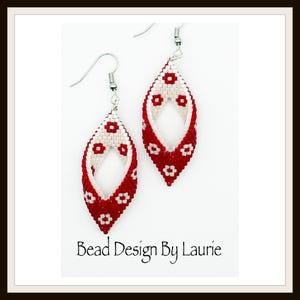 May include: A pair of handmade earrings with a red and white floral design. The earrings are teardrop-shaped, with a woven pattern of red beads and white floral accents. The text "Bead Design By Laurie" is at the bottom.