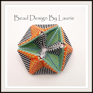 May include: A geometric bead design in black, white, orange, yellow, and blue. The design is a 3D star shape with a black and white striped background.
