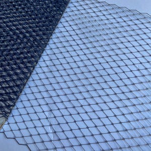May include: Close-up of two sections of black netting. One section features a diamond pattern, the other a more open, square design. The netting is likely for craft or decorative use.