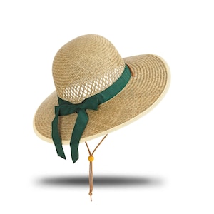May include: A wide-brimmed straw hat with a green ribbon and a brown cord.