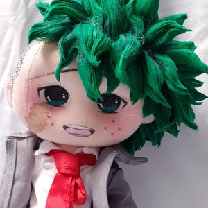 May include: A handmade plush doll of a character with green spiky hair, teal eyes, and freckles. The doll wears a white shirt, red tie, gray jacket, and black pants. The doll is approximately 10 inches tall.