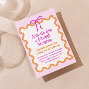May include: Pink and orange bridal shower invitation with a pink bow at the top. The text reads "Join us for a bridal shower honoring Hannah Caroline Peterson!" with the date, time, location, RSVP information, and website address.
