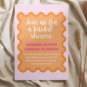 May include: A pink and orange bridal shower invitation with the text "Join us for a bridal shower honoring Hannah Caroline Peterson!"  Saturday November 18th at 12:00pm 12345 Willow Avenue Seattle WA RSVP to Ashley at 123 456 7890 www.myregistry.com