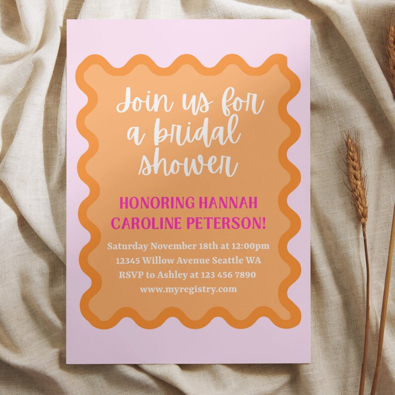 May include: A pink and orange bridal shower invitation with the text "Join us for a bridal shower honoring Hannah Caroline Peterson!"  Saturday November 18th at 12:00pm 12345 Willow Avenue Seattle WA RSVP to Ashley at 123 456 7890 www.myregistry.com