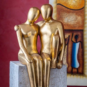 Modern sculpture / figure made of sandstone cast | Sitting couple | Modern decoration