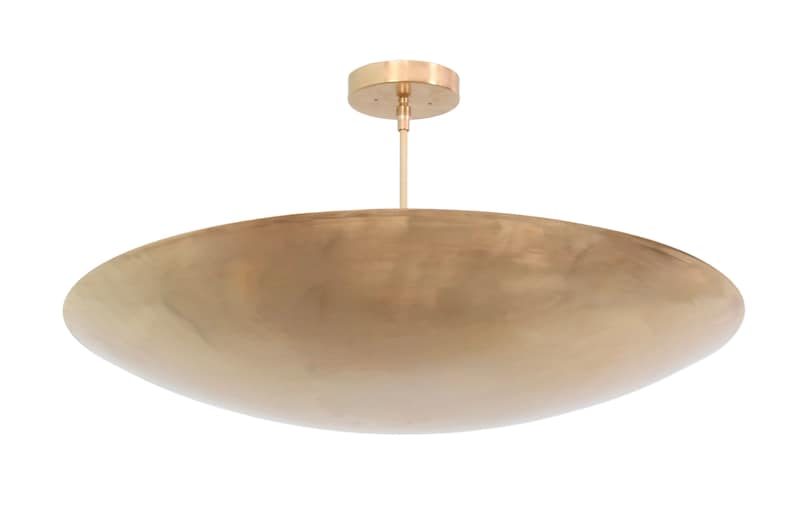 a large brass bowl hanging from a ceiling fixture
