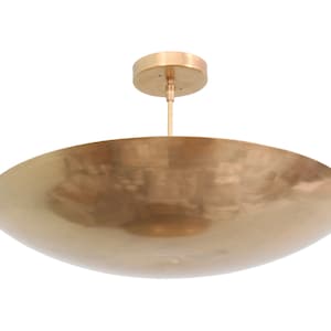 a large brass bowl hanging from the ceiling