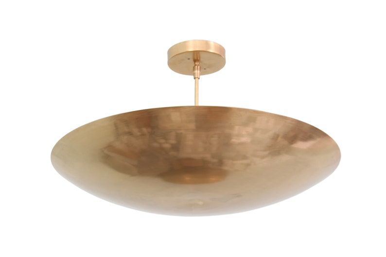 a large brass bowl hanging from the ceiling