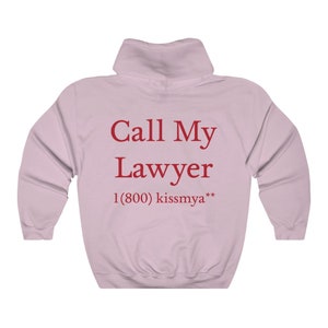 May include: Pink hooded sweatshirt with the text "Call My Lawyer 1 (800) kissmya**" printed on the back.