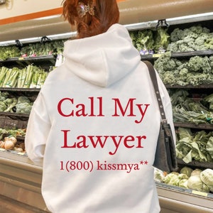 May include: White hoodie with red text that says "Call My Lawyer 1(800) kissmya**"
