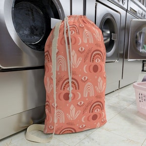 Peach colored Boho Rainbow Design Laundry Bag. Laundry Bag with strap. Laundromat bag