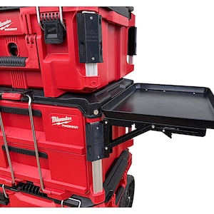May include: Red and black toolbox with a black folding work surface. The toolbox has the text "Milwaukee Packout" on the side.