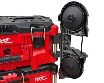 May include: A red Milwaukee Packout tool box with a black handle and a gray band saw attached to the side. The band saw has a black blade and a black and gray frame.