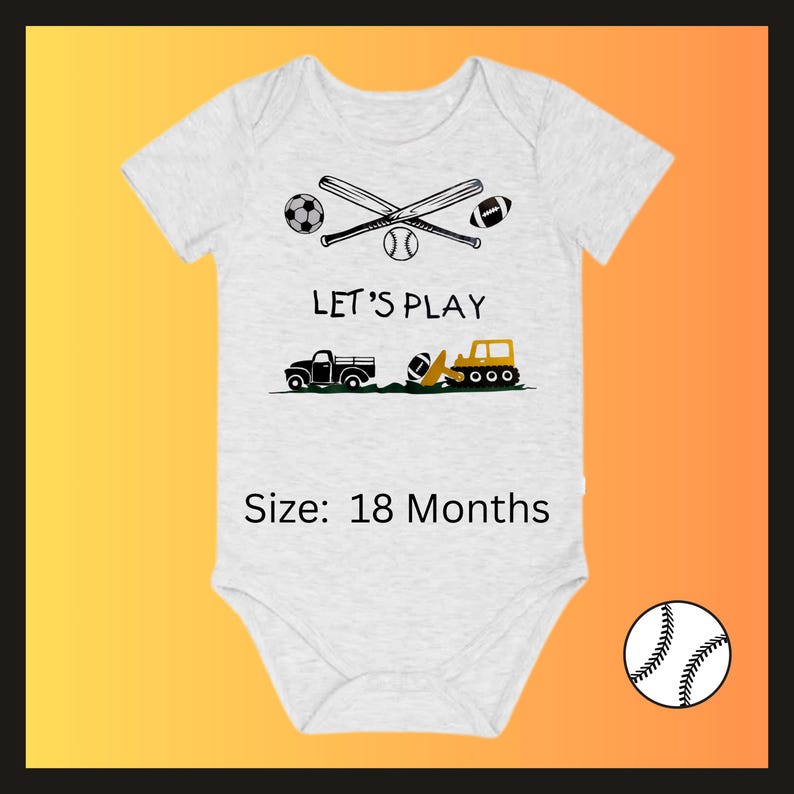 May include: A light gray baby onesie with a sports-themed graphic. The design includes crossed baseball bats, a soccer ball, a baseball, and a football. The text "LET'S PLAY" is above a truck, a football, and a construction vehicle. The size is 18 months.