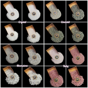 May include: A collage of ten images showcasing different types of crushed gemstones in small gold pans. The gemstones are labeled as Crystal, Emerald, Moonstone, and Ruby. Each pan contains a different color of crushed gemstone, including clear, green, white, and pink.