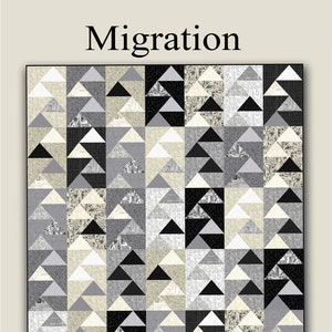 May include: A quilt pattern called "Migration" by Nancy Rink Designs. The pattern features a geometric design of black, white, and gray triangles. The quilt is 64 inches by 73 inches.