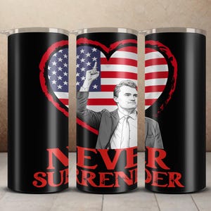 May include: Black insulated tumbler featuring a heart-shaped American flag design with a man raising his index finger. The words "NEVER SURRENDER" are in red. The tumbler has a silver lid.
