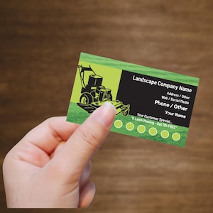 May include: A business card for a landscape company. The card features a lawnmower graphic on a green background, with the text "Landscape Company Name," contact information, and a special offer: "6 Lawn Mowing - Get 7th FREE."