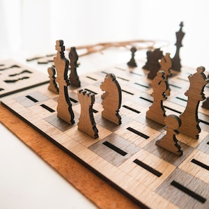 May include: A wooden chess set with brown and black pieces on a wooden board with a light brown and dark brown checkered pattern. The board is on a brown suede surface.