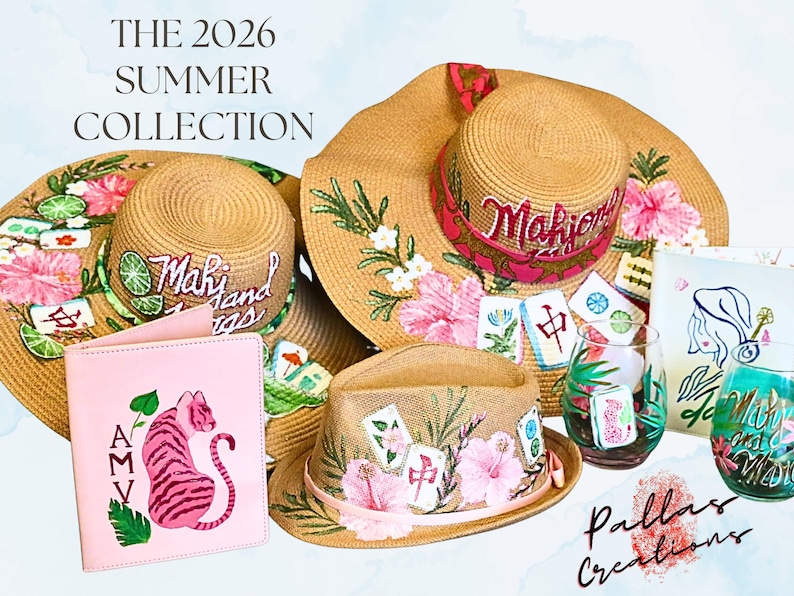 May include: The 2026 Summer Collection features several straw hats with floral and Mahjong tile designs. A pink passport holder with a tiger illustration and two decorated glasses are also displayed.