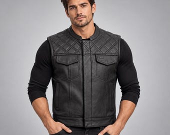 May include: A black leather vest featuring a quilted diamond pattern across the upper chest and shoulders, a mandarin collar, a central button-down placket, and two chest pockets with flaps. The garment is worn over a black long-sleeve shirt.