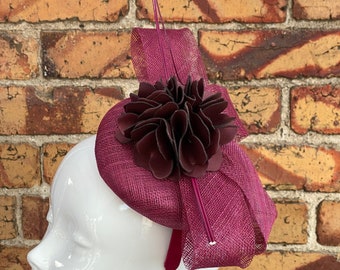 new plum purple sinamay fascinator with large sinamay loops floral centrepiece and a large stripped quill