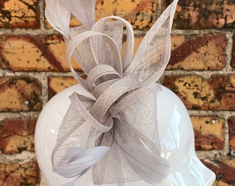 New grey sinamay looped fascinator headband with added feathers
