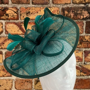 Large sinamay emerald green looped fascinator with feathers
