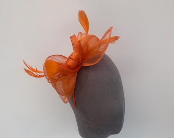 Orange sinamay looped bow fascinator headband with added feathers