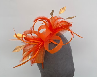 Orange loop bow fascinator with added Gold diamond trimmed feathers headband and clip