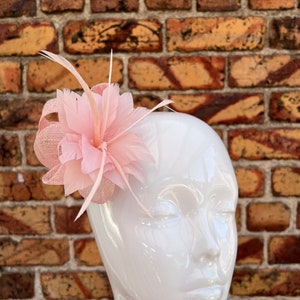 New pink small sinamay fascinator and brooch with curls and feather flower