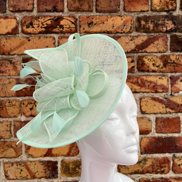 Large sinamay mint green looped fascinator with feathers