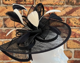 Large sinamay black looped fascinator headband and clip with cream feathers