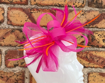 New bright pink cerise loop bow fascinator with added orange feathers headband and clip