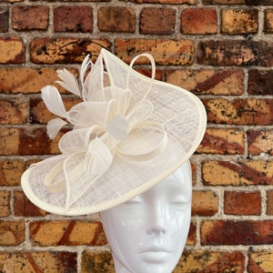Large sinamay cream looped fascinator with feathers
