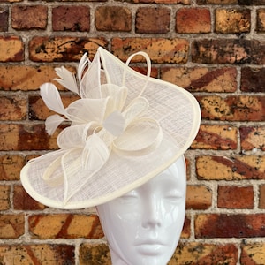 Large sinamay cream looped fascinator with feathers