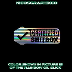 May include: A holographic sticker with the text "CERTIFIED SHITBOX" in a dripping font, with a checkmark inside a hexagon shape. The text "NICOSGRAPHIXCO" and "COLOR SHOWN IN PICTURE IS OF THE RAINBOW OIL SLICK" are also present.