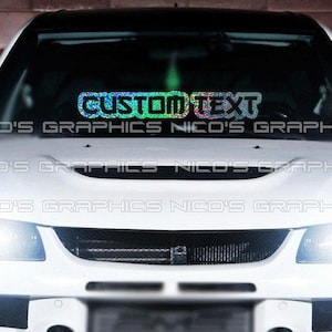 May include: A white car with a custom text decal on the windshield. The decal is iridescent and says "CUSTOM TEXT".