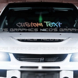 May include: A white car with a custom text decal on the windshield. The decal is in a rainbow color scheme and says "custom text".