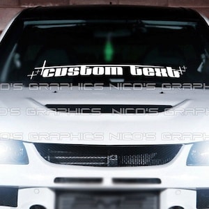 May include: White car windshield decal with the text "#custom text#" in black lettering.