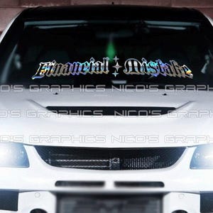 May include: A white car with a windshield banner that reads "Financial Distralka" in a holographic, stylized font. The car's headlights are on, and the text "NICO'S GRAPHICS" is printed across the bottom of the windshield.